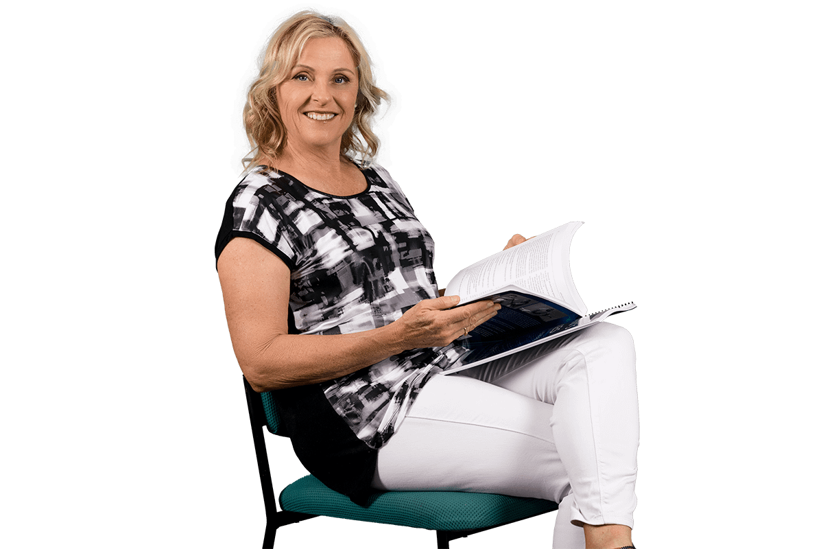 Paula Nutting, your musculoskeletal specialist sitting and smiling
