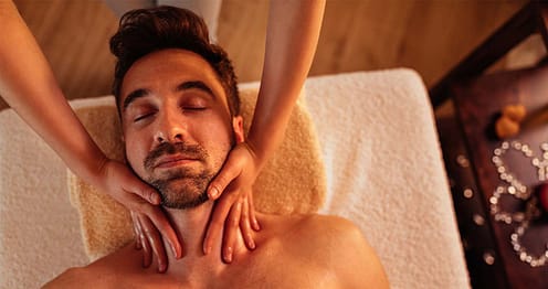 both hands massaging man's neck