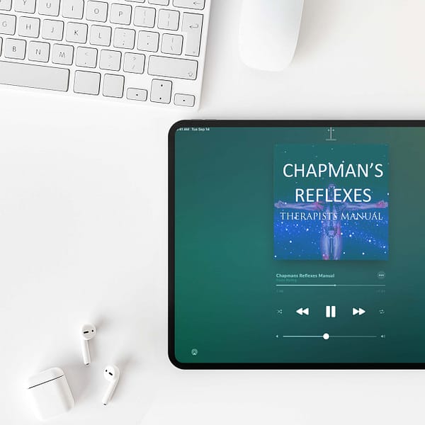 Image of white keyboard, mouse, air pods, air pods case, ipad playing chapmans reflexes audio book