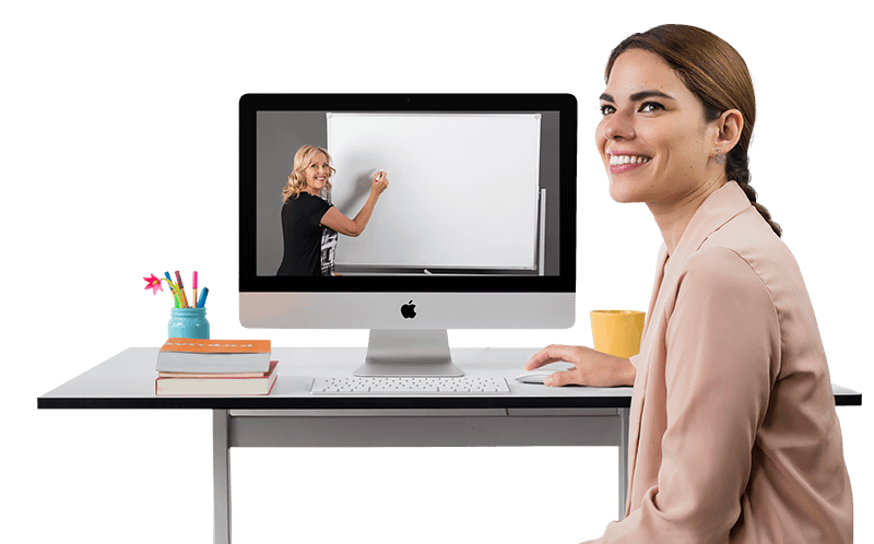 woman sitting and smiling in front of an Apple iMac desktop computer watching Paula Nutting teach