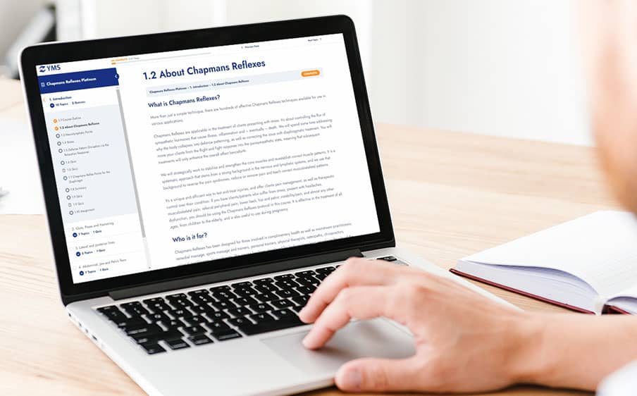 hand typing on an Apple Macbook laptop